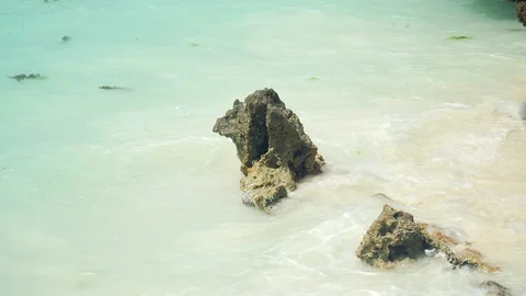Small rocky stone is washed by waves ocean waves Stock Footage 105417904