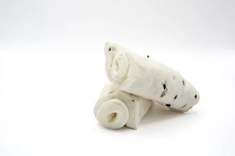 Small rolled white cheese pieces isolated on white background Stock Photos