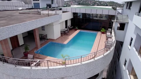 Small rooftop pool on tall hotel complex in Mwanza city Stock Footage 234185699