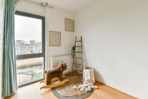 A small room with a large window Stock Photos