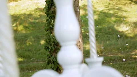 Small roses tied to the tree through a white light candle holder. Decor for Stock Footage 77002561