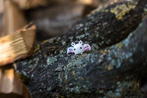 A small round white creature with wings and ears made of beads. A concept of Stock Photos