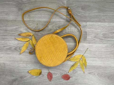 Small round yellow leather mini bag Stock Photos