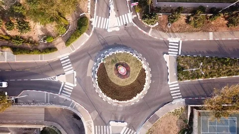 Small roundabout with traffic - Top down... | Stock Video | Pond5