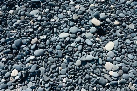 Small rounded pebbles on the beach Stock Photos