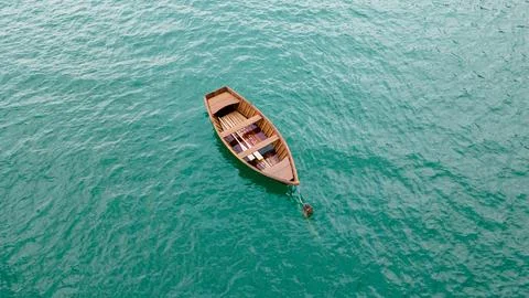Small row boat floating on clear water Stock Photos