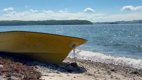 Small rowing boat on stony beach Stock-Footage 337303078