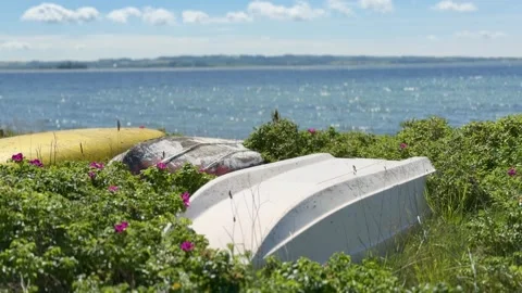 Small rowing boat upside down on coastal shore Stock-Footage 337303085