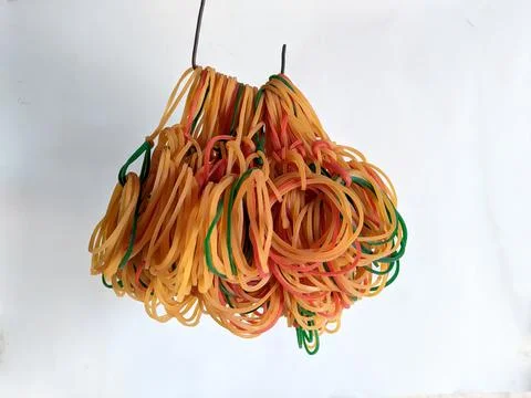 Small rubber bracelets that are made to tie things together and are colorful Stock Photos