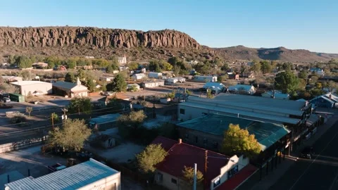 Small rural Texas town at sunrise, beautiful mountain backdrop with local Stock Footage 298197553