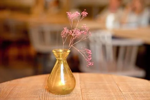 Small rustic vase with flowers on the table Stock Photos