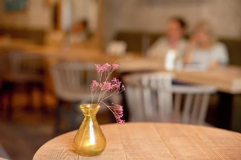 Small rustic vase with flowers on the table Stock Photos