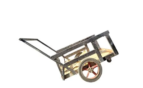 Small rusty old black cargo cart on white background Foto stock