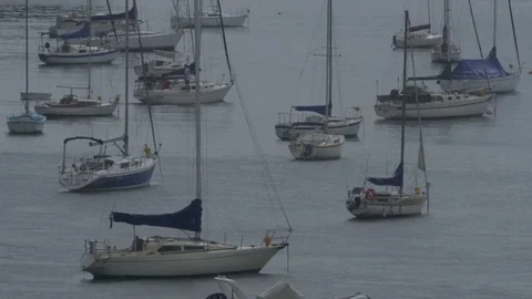 Small Sail Boat Leaving Harbor During Rainstorm 库存影片 72436802