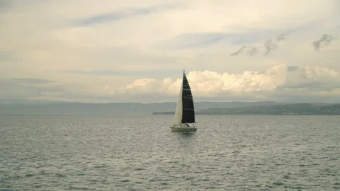 A small sailboat is sailing in the ocean Stock Footage 155030457