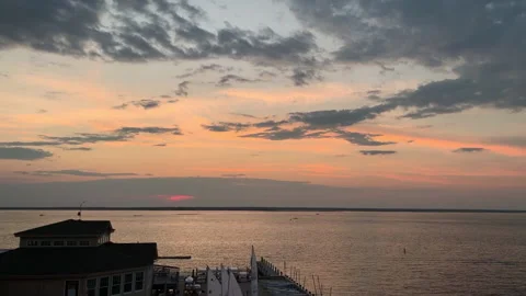 Small sailboats return to shore during beautiful sunset in Surf City NJ Stock Footage 137197207