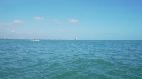 Small sailing and speed boat on the ocean horizon Stock Footage 273675355