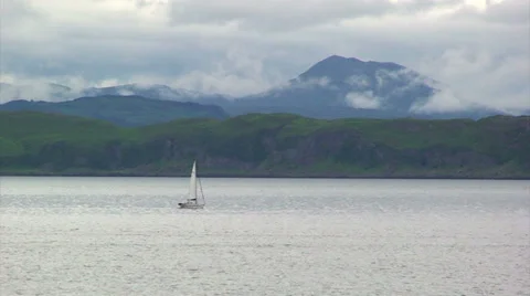 Small sailing boat on cloudy loch Stock Footage 39815728