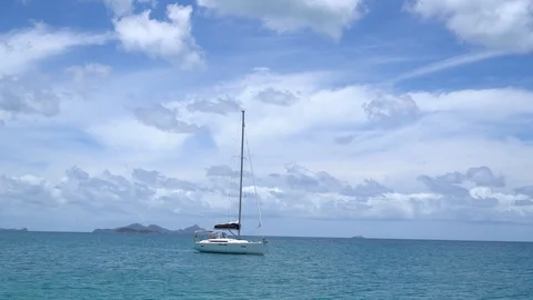 Small sailing boat in the middle of the ocean Stock Footage 98941859