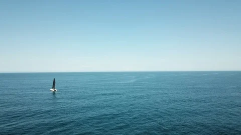 Small sailing boat in the middle of the ocean Stock Footage 98947598