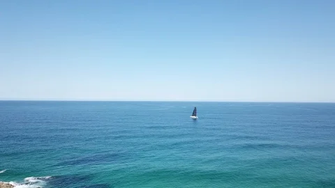 Small sailing boat in the middle of the ocean Stock-Footage 98953979