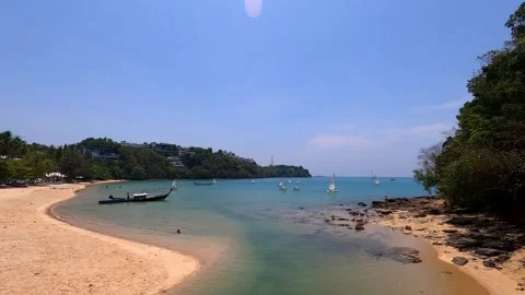 Small sailing boats float near the beautiful sandy beach. Stock Footage 243279607