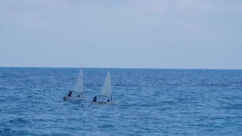 Small sailing boats gliding on the open blue sea, calm maritime leisure scene Vídeos de archivo 341585715