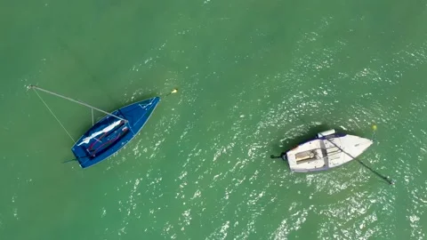 Small sailing yachts are anchored in the middle of the sea Stock Footage 176704933