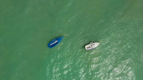 Small sailing yachts are anchored in the middle of the sea Stock Footage 194670992