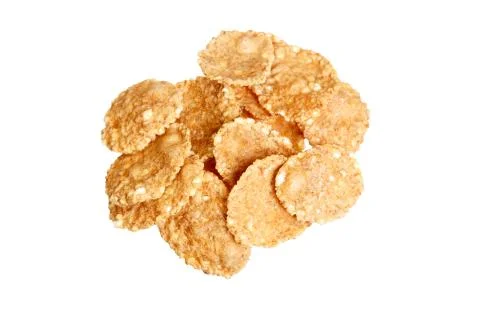 Small sampling of corn flake cereal in a pile isolated against a white Stock Photos