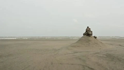 Small Sand Castle and Mud Sculpture on Empty Sandy Beach Ocean Shore Stock Footage 239173386