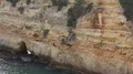 Small sand stone cliff hole at Algarve coastline Portugal 4k or 4k+ Resolution