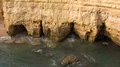 Small sand stone cliff holes at Algarve coastline Portugal 4k or 4k+ Resolution