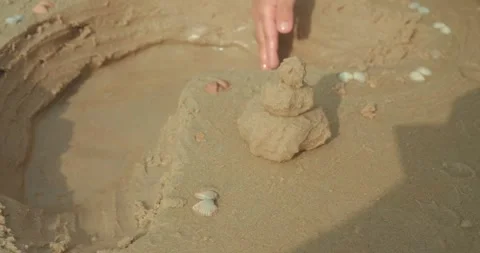 Small sand tower with shells on beach close up Stock Footage 333932614