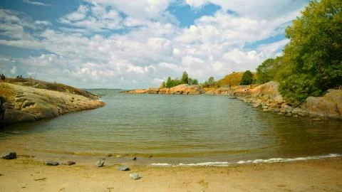 A small sandy bay beach surrounded by stone hills Foto stock