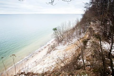 Small sandy beach cliff in winter Stock Photos