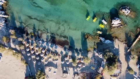 Small Sandy Cove of Kolymbithres Beach full of Straw Sun Umbrellas, Paros Video stock 291285427