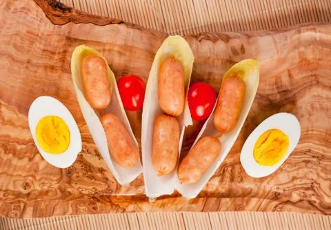 Small sausages in chicory Stock Photos