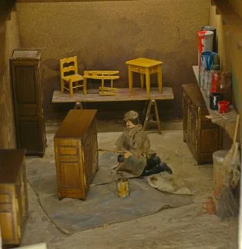 Small scale model representing carpenter making wooden furniture Stock Photos