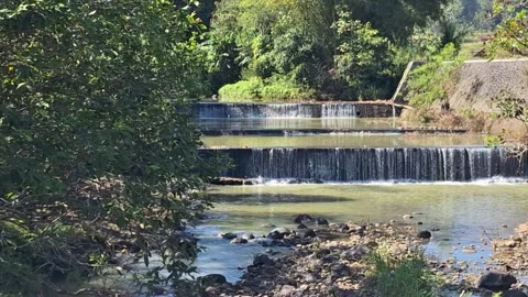 Small scenic river waterfall flowing over rocks Stock Footage 337050560