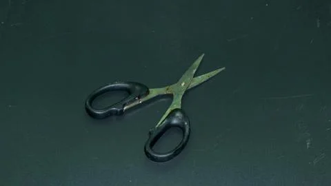 Small scissors with a black handle Photos