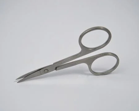 Small scissors made of stainless material on a white background Stock Photos