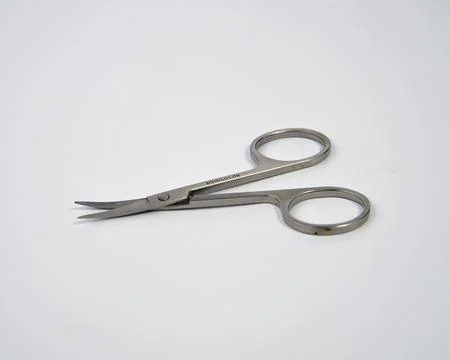 Small scissors made of stainless material on a white background Stock Photos