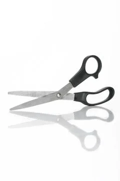 Small scissors with reflection in studio Stock Photos
