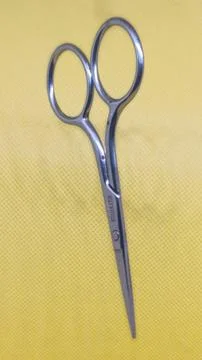 Small Scissors on Yellow Stock Photos