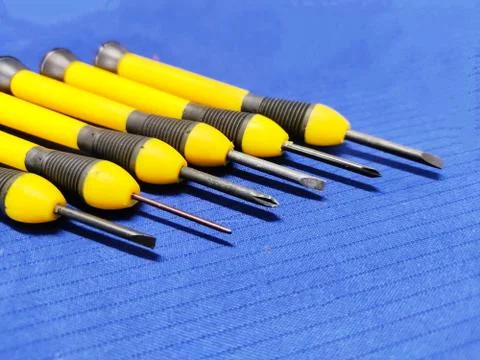 Small Screw Driver mini precision set on blue textured background. 스톡 사진