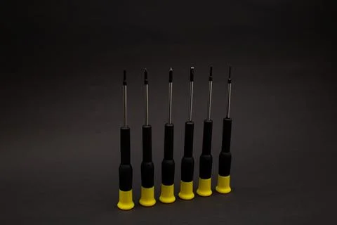 Small screwdrivers on black background Stock Photos