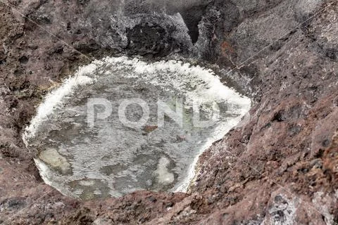 Small sea salt concentrate puddle on rocky ground. Stock Photos