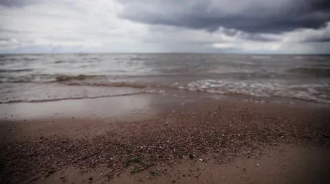 Small sea waves on beach with tiny stones. Grey cloud sky. Summer. Slider pan 스톡 동영상 59907239