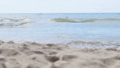 Small Sea Waves on Empty Beach. Waves roll out a Perfectly Smoothly Sandy Beach Stock Footage 137916616
